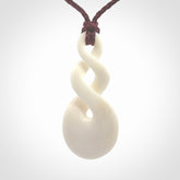 These are very cool, simple double twist pendants carved from natural bone. We have bound these in a adjustable cord and will ship them to you wherever you are. Hand carved by NZ Pacific.