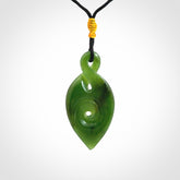 Ross Crump twist with koru pendant. Hand carved from rare New Zealand jade this is a beautiful pounamu pendant. The cord is a black colour and is length adjustable. It has a little spiral floret popper at the top of the pendant. It is a delicate and very beautiful greenstone pendant. For sale online by NZ Pacific.