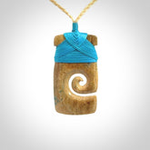 Hand carved Woolly Mammoth Tusk toki with koru pendant. Toki with koru necklace carved from ancient woolly mammoth tusk. Provided with adjustable cord and packaged in a woven kete pouch.