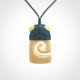 Hand carved Woolly Mammoth Tusk toki with koru pendant. Toki with koru necklace carved from ancient woolly mammoth tusk. Provided with adjustable cord and packaged in a woven kete pouch.