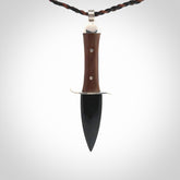 A striking hand carved knife pendant that we've called the blade. These are carved with a jade head and a hardwood handle. The cords are hand plaited in our waxed polyester which is robust, strong and durable. We ship these worldwide with express courier.