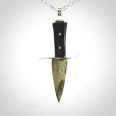 A striking hand carved knife pendant. These are carved with a green jade head and a hardwood handle. The necklace is sterling silver. We ship these worldwide with express courier.