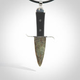 A striking hand carved knife pendant. These are carved with a green jade head and a hardwood handle. The necklace is made of leather and has a clasp fixture. We ship these worldwide with express courier.