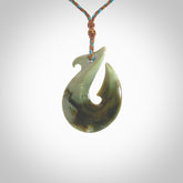 Hand carved New Zealand Jade Hook Pendant. Matau necklace hand carved. Jade Hook pendant provided with adjustable cord and packaged in a woven kete pouch. Delivered with Express Courier.