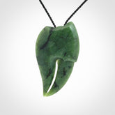 This large crab claw pendant is carved from a lovely deep green piece of New Zealand jade. It has an adjustable black coloured cord which can be slipped over the head and adjusted to the length that you prefer. Hand carved in New Zealand from our local jade by Kyohei Noguchi.