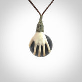 This is a very cool pendant that we've had carved for all you Basketball fans. The DUNK is a pendant with a deer antler hand holding a black jade basketball. We provide this on an adjustable cord, and we ship worldwide. A very cool pendant, different, edgy and very wearable.