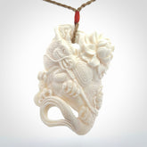 This is a hand carved bone baby dragon pendant. It is made from bone and has an adjustable tan coloured cord. This is a large sized necklace and is a very unique, one only, pendant that is a piece for art lovers.