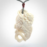 This is a hand carved bone baby dragon pendant. It is made from bone and has an adjustable grey coloured cord. This is a large sized necklace and is a very unique, one only, pendant that is a piece for art lovers.