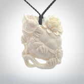 This is a hand carved bone baby dragon pendant. It is made from bone and has an adjustable black coloured cord. This is a large sized necklace and is a very unique, one only, pendant that is a piece for art lovers.