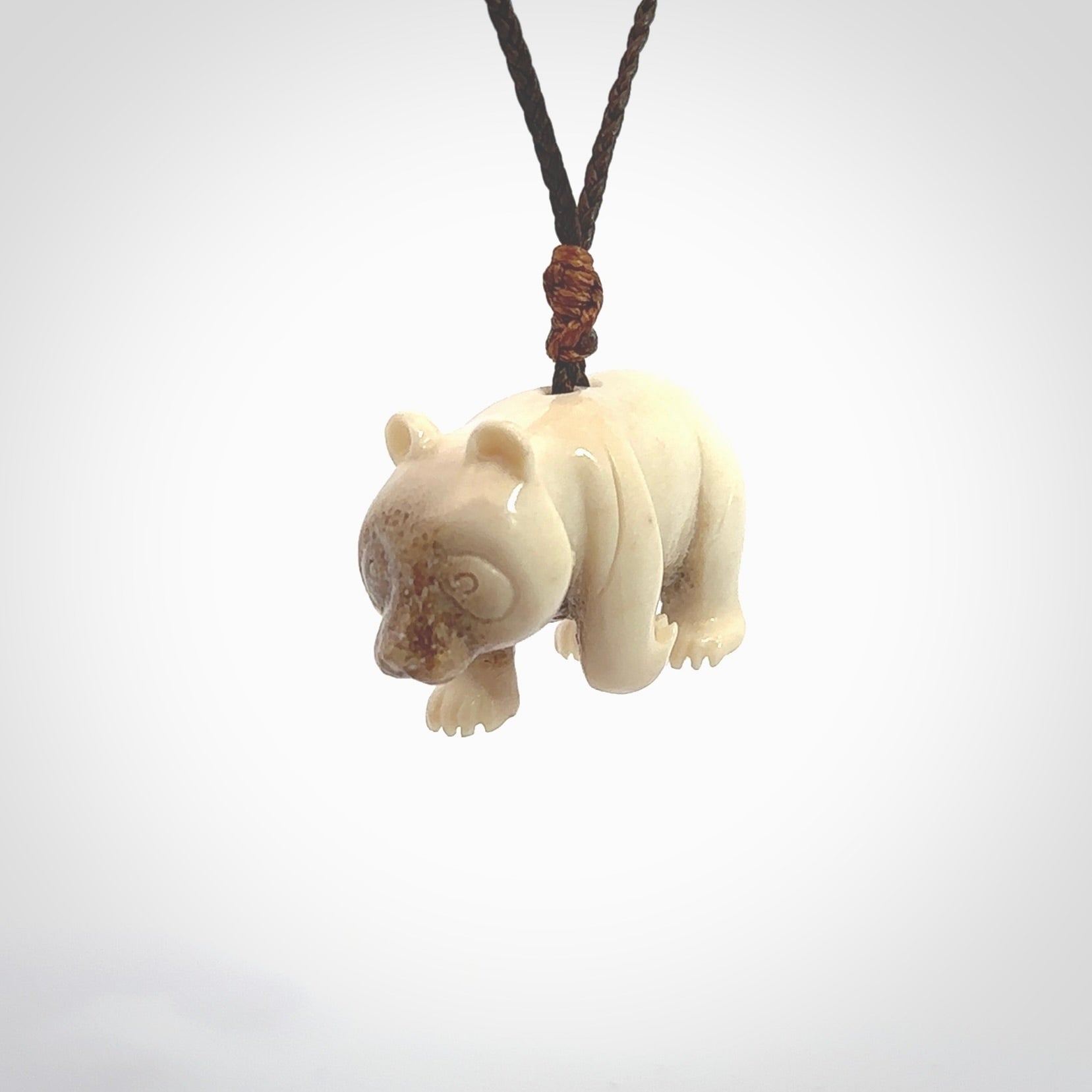 This picture shows a pendant that we designed in Deer Antler. It is a little Panda bear that has a walking stance and is carved in detail. A really attractive and eye-catching piece of handmade jewellery. The cord is hand plaited braid and the length can be adjusted.