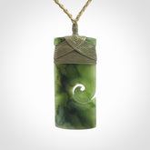 New Zealand jade toki koru pendant. Hand carved in New Zealand. Hand made New Zealand Jade jewellery. Provided with an adjustable cord and packaged in a woven kete pouch.