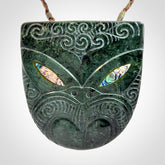 Hand carved New Zealand Jade wheku pendant with paua shell eyes