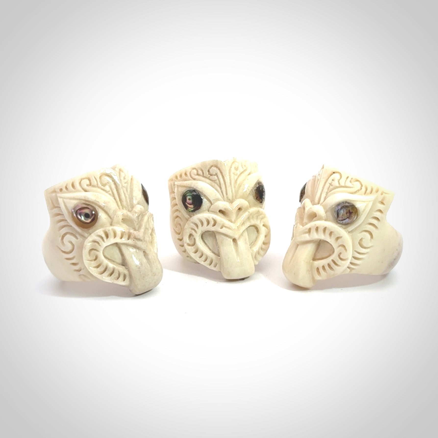 Hand carved deer antler wheku rings with paua shell eyes.