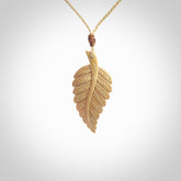 Hand carved woolly mammoth tusk fern pendant. Made in New Zealand. Unique hand made gifts from NZ Pacific. Hand carved fern necklace from ancient woolly mammoth tusk.
