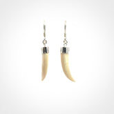 Hand made mammoth tusk drop earrings. Made by NZ Pacific - handmade jewellery for sale online. Woolly Mammoth Tusk fang style earrings, packaged in a woven kete pouch.