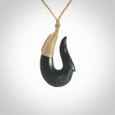 This photo shows a greenstone hook, or matau, pendant. It is a beautiful deep green jade. The cord is plaited oat coloured and the length can be adjusted.