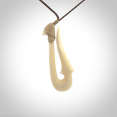 Hand made bone hook, or matau, pendant. The cord can be adjusted. It is a large sized pendant and is well carved. A beautiful piece of art to wear, hand carved jewellery. Delivered in woven kete pouch with express courier.