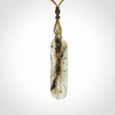 This is a hand carved feather pendant made from Labradorite stone.