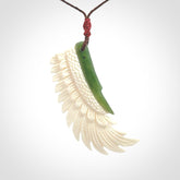 This photo shows a beautiful bone and jade wing pendant.