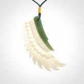 This photo shows a beautiful bone and jade wing pendant.