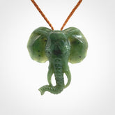 This is a hand made elephant pendant. Carved in a beautiful darker green piece of British Columbian jade. The cord is hand-plaited in a gingernut brown colour and is length adjustable. Provided in a woven kete pouch and delivered with express courier.