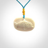 A beautiful dolphin pendant carved in mammoth tusk