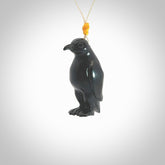 This pendant is a hand carved YELLOW EYED penguin. We've carved this from a lovely piece of black jade and we provide it with an adjustable cord. Shipping is free worldwide.