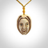Hand carved incredible stained bone gargoyle face carving. A stunning work of art. This pendant was hand carved in bone with buffalo horn inlay for the eyes by Yuri Terenyi. A one off collectors item that has been hand crafted to be worn or displayed.