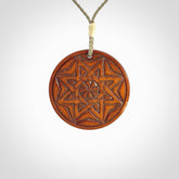 Hand carved natural stained bone contemporary disc pendant with creative and unique carvings on the front face of each individual piece.