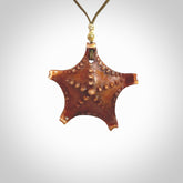 Hand carved bone starfish pendant. Ocean themed pendants carved by NZ Pacific. Moana pendants for sale online. Hand made stained bone sea star by Yuri Terenyi. We provide these starfish on adjustable cords. Postage is included in the price.