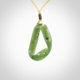 This little piece is a hand carved möbius ribbon pendant. We've carved this from Nephrite Jade. It has very subtle colour variations in the stone and is a delightful, small and artistic piece of jewellery.