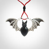 This is a hand carved bat pendant. It is made from Black Jade and Sterling Silver. This is a medium sized necklace and is a very unique, one only, pendant that is a collectors piece. Provided with red adjustable cord.