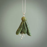 This picture shows a beautiful flower jade flower pendant with sterling silver flowers. This is a spectacular work of art and is a one off piece. Hand carved from New Zealand Flower Jade with sterling silver flowers, replicating a beautiful flower.