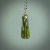 This kowhai flower drop pendant is beautifully hand made with gorgeous flair. It is fashionable and perfect for a women with style. Hand carved from a gorgeous piece of New Zealand jade with sterling silver - this is an elegant and beautiful piece of art to wear.