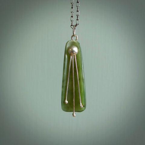 This kowhai flower drop pendant is beautifully hand made with gorgeous flair. It is fashionable and perfect for a women with style. Hand carved from a gorgeous piece of New Zealand jade with sterling silver - this is an elegant and beautiful piece of art to wear.