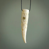 A mythical bird head hand carved from bone with Paua shell eyes. This is a one only bird head with long beak necklace hand made from natural bone with paua shell eyes. This bird head has engravings and is a magnificent piece of art to wear. It is delivered on a black adjustable cord.