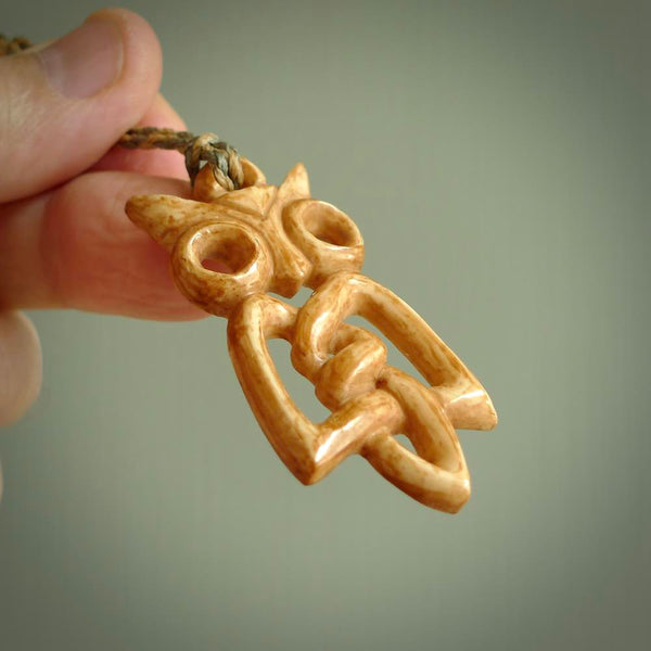 A traditional Celtic Owl design carving, hand made for us from bone. This is a work of art and is a collectable piece of traditional bone carving. It can be worn as a special piece of jewellery or displayed. This is art made to wear at its finest.