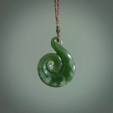 This pendant is a large sized and beautiful koru necklace carved from an orange and green piece of New Zealand Flower Jade. Ross Crump carved this piece for us so the workmanship is outstanding. Handmade in New Zealand, a beautiful piece of jade jewellery.