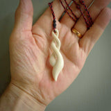 A handcarved masterpiece. A complex twist pendant carved from bone by Yuri Terenyi for NZ Pacific. This is a true piece of wearable art which is collectible. A one-off masterpiece and quite unique.