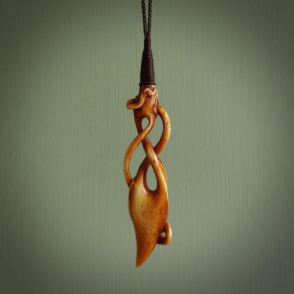 WILDERNESS is carved from cow bone and stained with a homemade tea dye. It is a unique piece of wearable art that is sure to catch the eye. The shape is a complex twist form and has been beautifully hand carved by bone carver Yuri Terenyi.