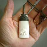 A hand carved bone toki with NZ Pacific logo engraving. Unique hand made jewellery from New Zealand Pacific.