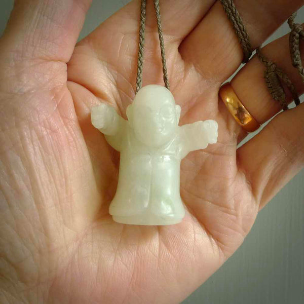 Jadeite monk pendant with adjustable necklace cord. Hand carved by NZ Pacific. Handmade jewellery for sale online. The cord is a hand plaited khaki green colour, which is length adjustable. Peaceful man necklace for men and women. Contemporary necklace hand made from Jadeite.