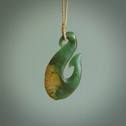 Hand carved flower jade matau pendant. Hand made in New Zealand by Ric Moor. Unique and authentic jade jewellery for sale online. Jewellery hand made by NZ Pacific. Carved by NZ Pacific.