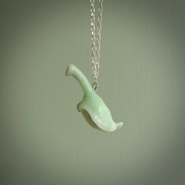This picture shows a flower shaped pendant, hand carved from New Zealand Inanga jade with an Opal centre. We will provide this with a sterling silver chain and delivered to you with express courier. This is a one only pendant and is a beautiful work of art to wear.