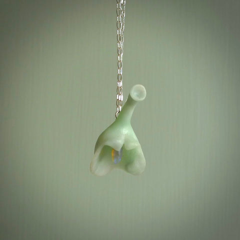 This picture shows a flower shaped pendant, hand carved from New Zealand Inanga jade with an Opal centre. We will provide this with a sterling silver chain and delivered to you with express courier. This is a one only pendant and is a beautiful work of art to wear.