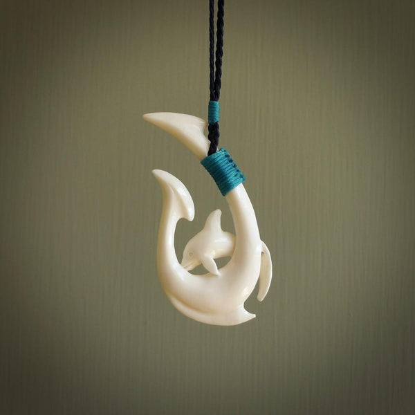 Hand carved bone hook with dolphin. This is a marine-themed pendant which we have made for dolphin lovers and for those of us that love the sea. This piece is handcarved from natural bone  and is shipped worldwide free.