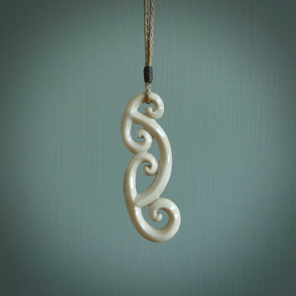 This is a wonderful, gently curved piece with a multiple koru design. We've carved this from deer antler and bind it on hand-plaited cords of various colours. Order yours now on NZ Pacific at www.nzpacific.com