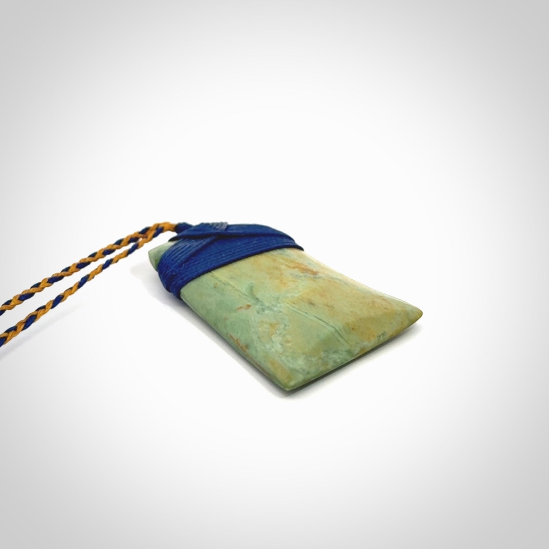 Hand carved Toki pendant from a lovely piece of local New Zealand Flower Jade. We have suspended this from a 4-plait beige cord which can be adjusted with a couple of slip knots and beige binding.