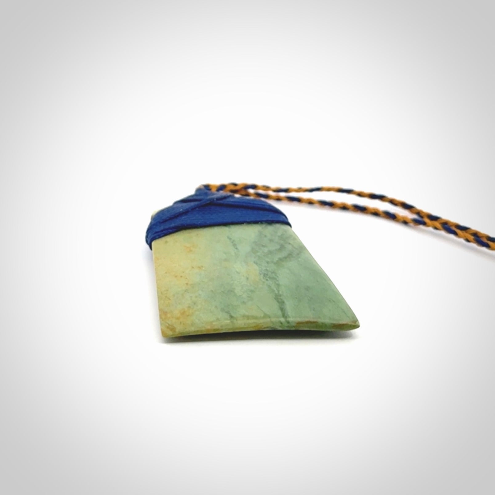 Hand carved Toki pendant from a lovely piece of local New Zealand Flower Jade. We have suspended this from a 4-plait beige cord which can be adjusted with a couple of slip knots and beige binding.