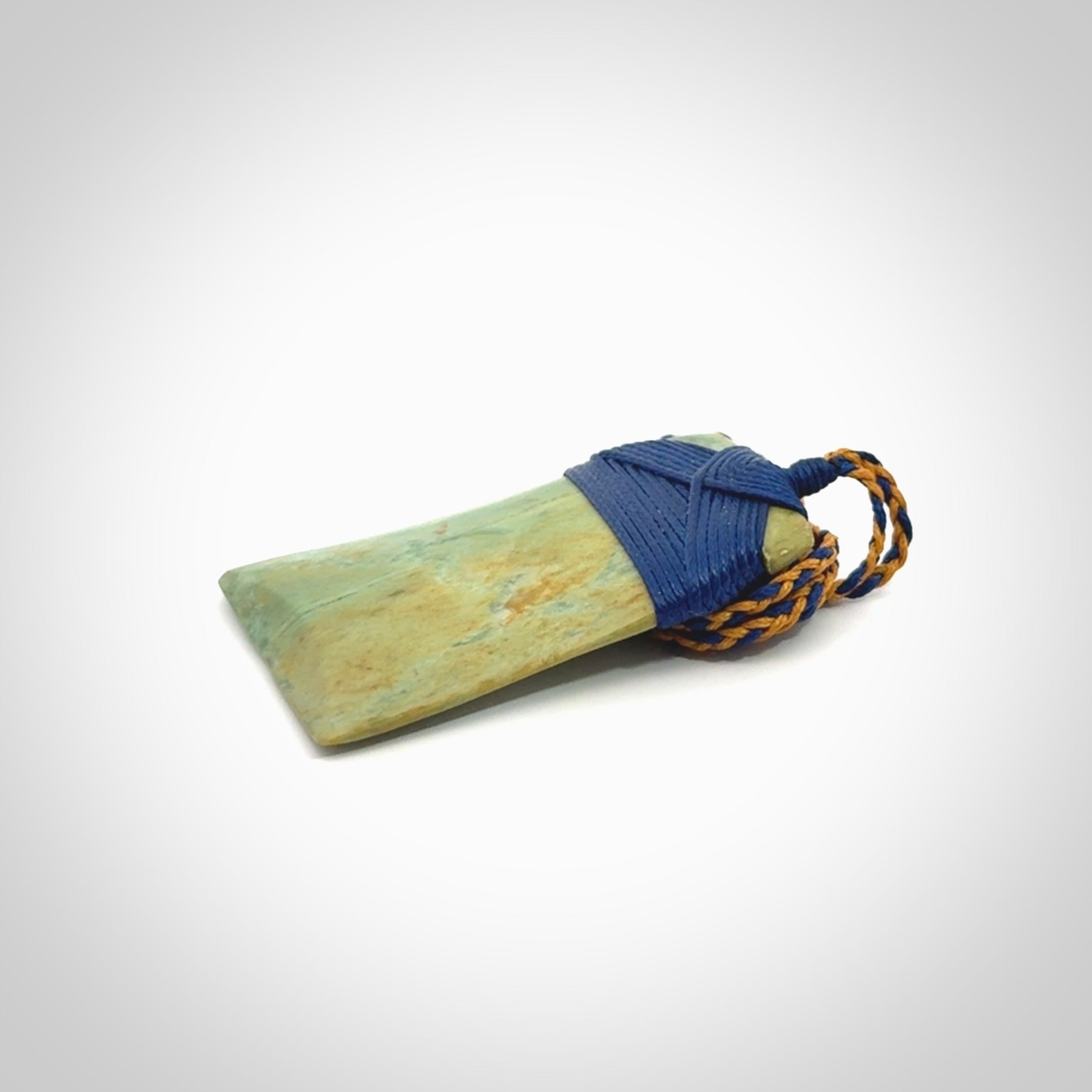 Hand carved Toki pendant from a lovely piece of local New Zealand Flower Jade. We have suspended this from a 4-plait beige cord which can be adjusted with a couple of slip knots and beige binding.